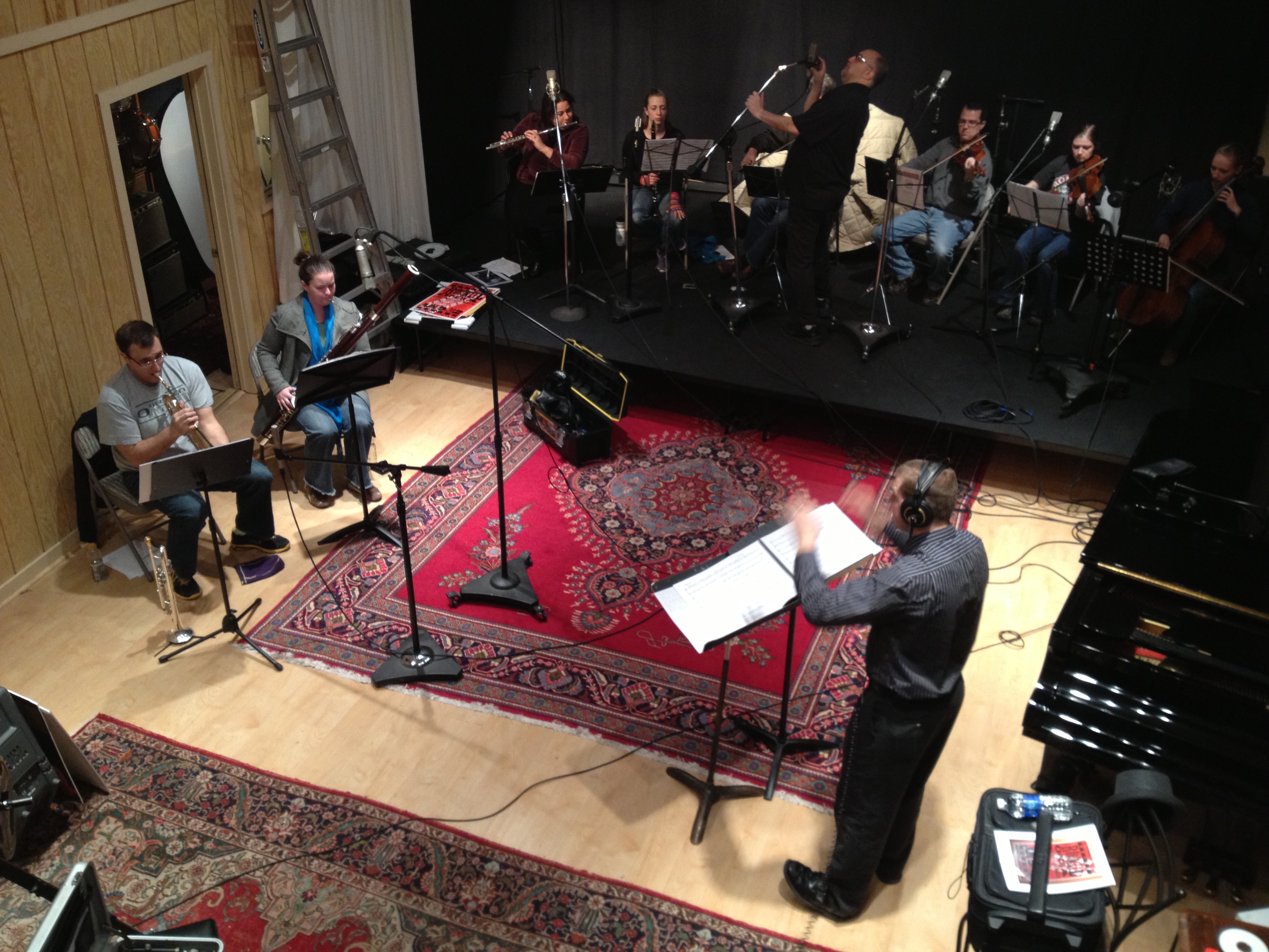 Photo of Jeffrey Dokken conducts the chamber orchestra while recording engineer Jeff Gruber adjusts microphones.