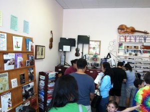 Photo of Lashof Violins in Gaithersburg, Maryland, was packed with customers in September 2013. A Roadkill Opera CDs can be seen in the center of the photo; the sheet music and If You See Roadkill, Think Opera are visible to the left