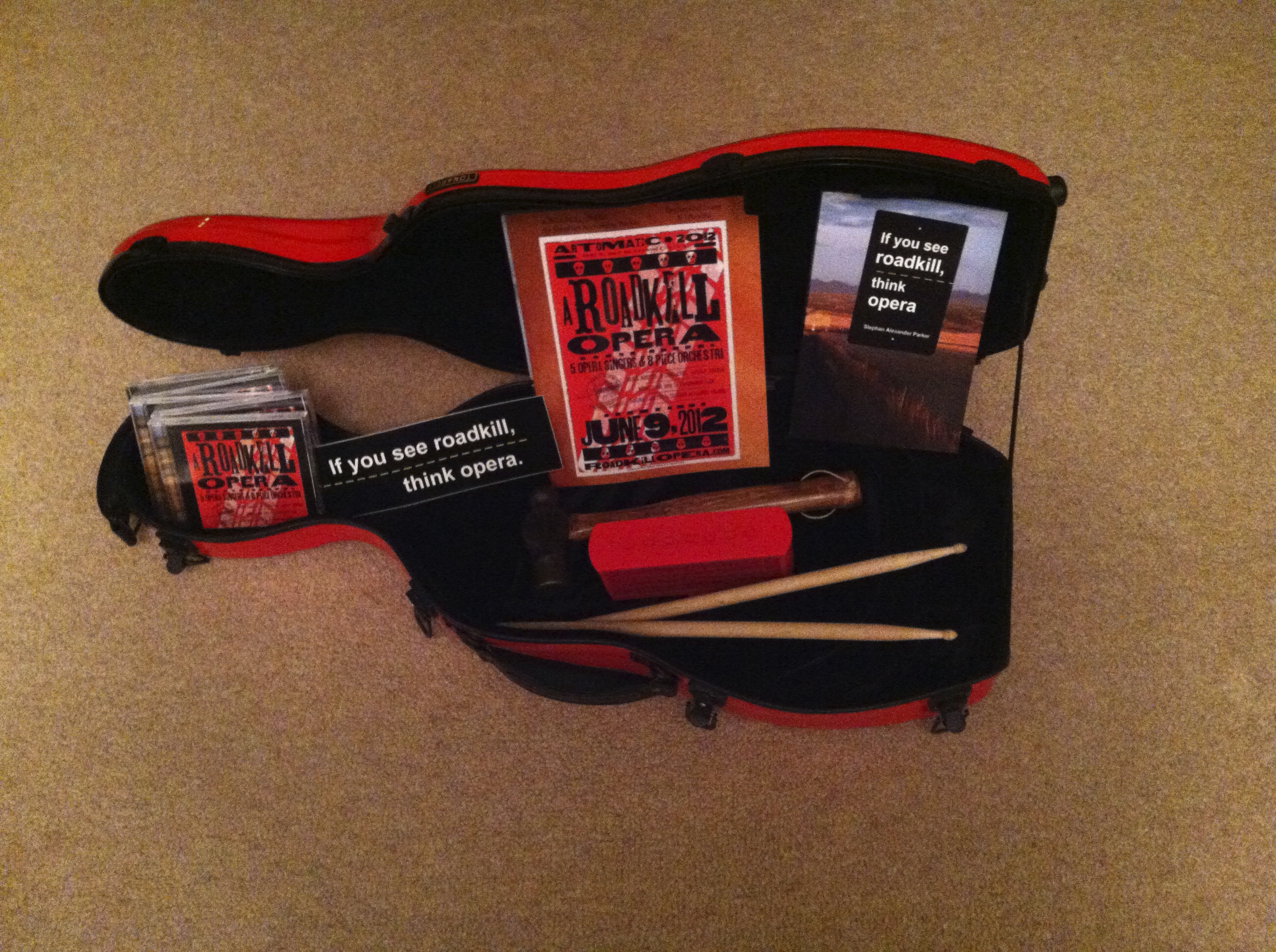 Photo of A viola case is used for transporting and displaying the CD and books associated with A Roadkill Opera and If You See Roadkill, Think Opera
