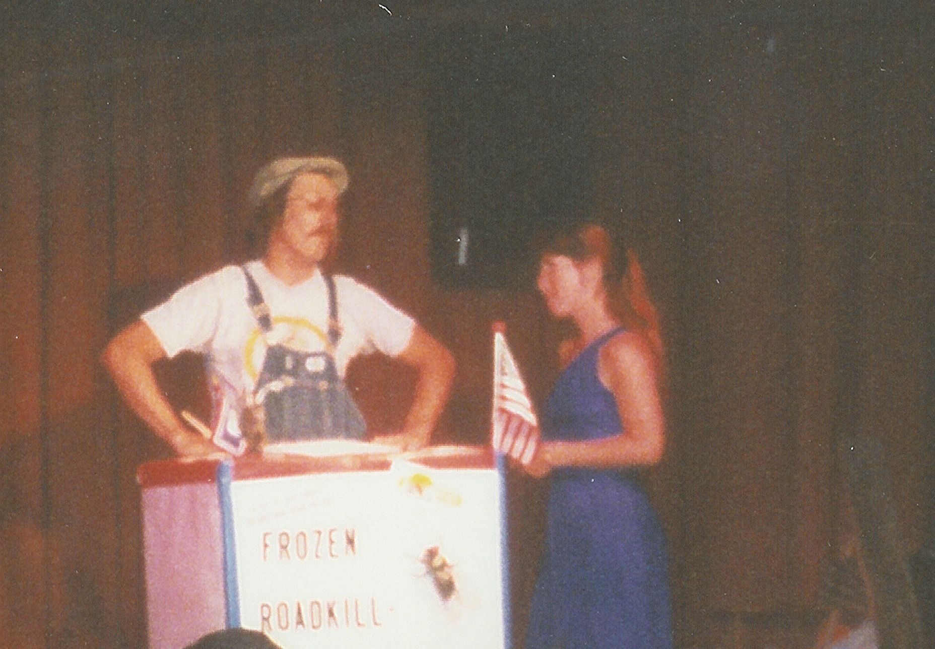 Photo of Ed Bachtel selling roadkill to Holly Danner in the classic sketch Frozen Roadkill On A Stick during the 1988 run of Roadkill!!! in the Greenback Lounge at the Wort Hotel (enter through the Silver Dollar Bar).