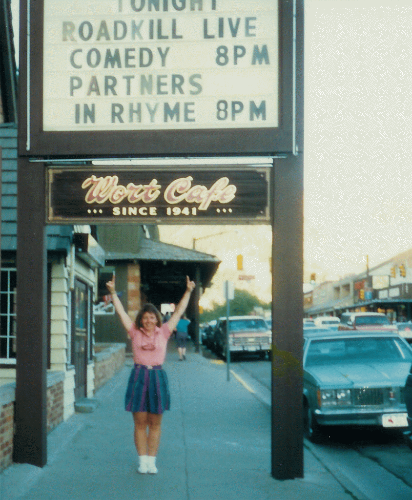 Photo of DJ Choupin standing under the marquee for the Wort Hotel advertising Roadkill Live Comedy 8 pm