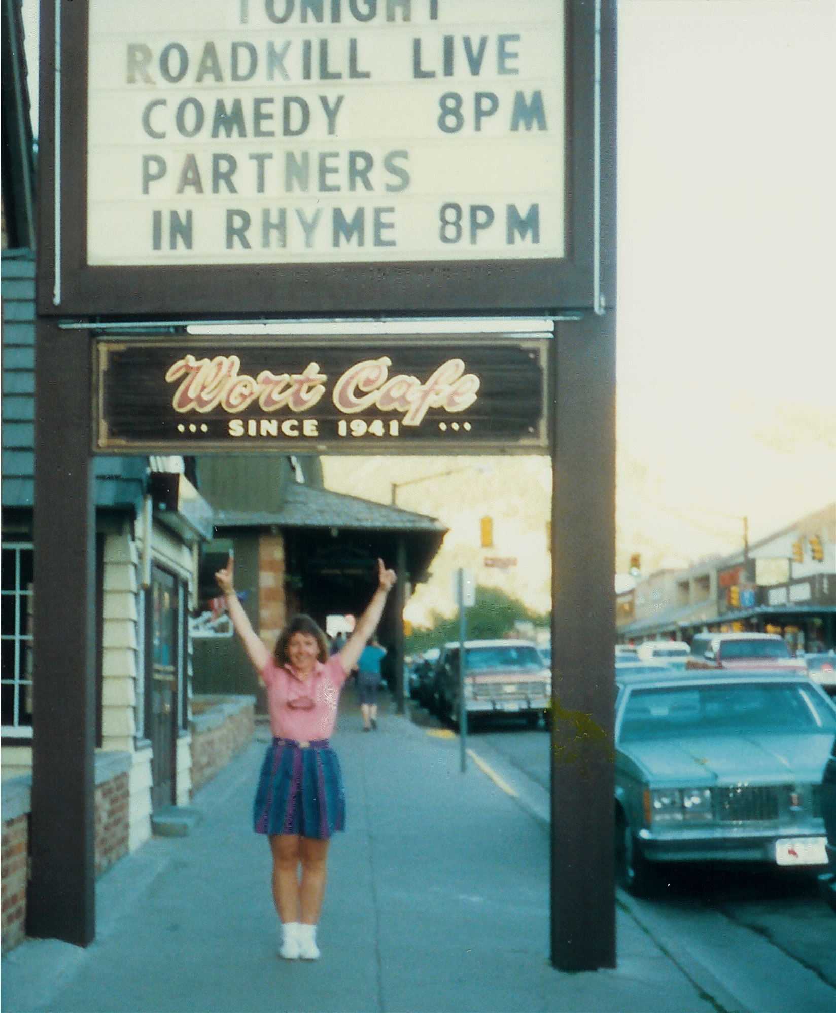 Photo of DJ Choupin standing under the marquee for the Wort Hotel advertising Roadkill Live Comedy 8 pm