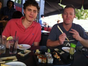 Photo of videographer Ben Ganz (at right) and assistant Jason Ganz eating sushi.