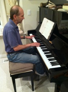 Photo of David Greenstein, a multiple threat: singer, songwriter, pianist, seen here at his piano performing an original song