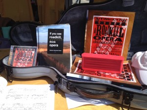 Photo of the gray, cello-shaped viola case from McKay's of Nashville made a fine tabletop display for A Roadkill Opera at the 2014 Gaithersburg Book Festival.