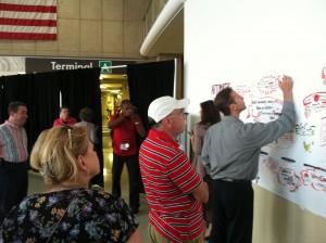 Photo of artist marking the scroll of paper at Artomatic Takes Flight.