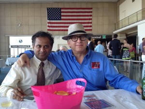 PHoto of Nanda Srinivasan and Stephan Alexander Parker under an American flag at Artomatic Takes Flight.