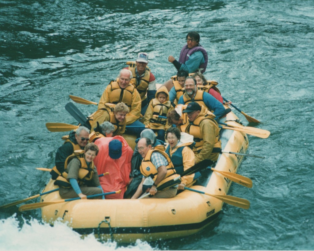 Photo of Parker guiding a raft full of paddlers
