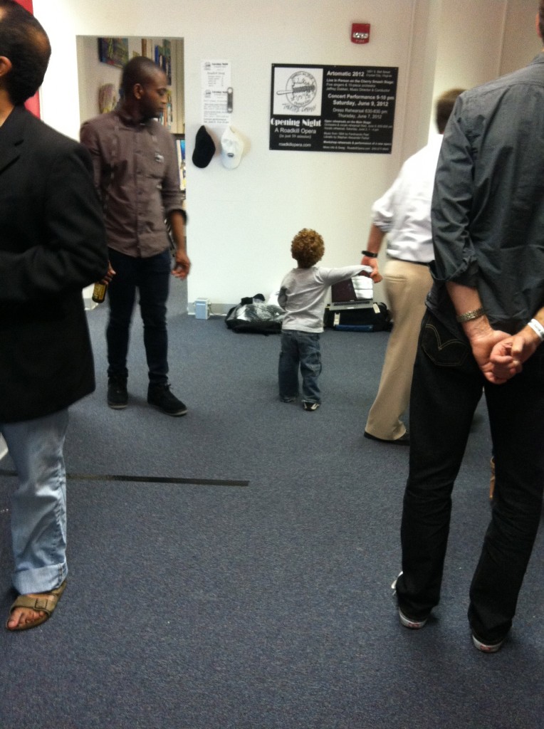 Photo of gallery crowd, including a 4 year old boy looking at the Roadkill Opera mockup