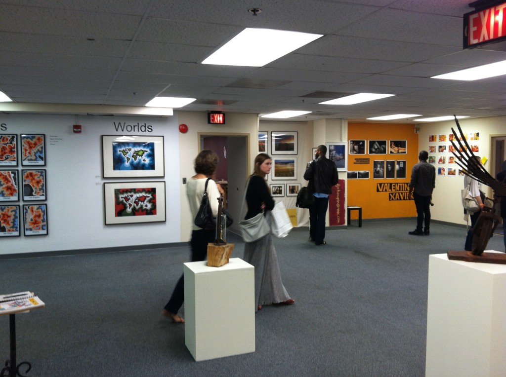 Photo of people looking at exhibits of DJ Choupin and others at Artomatic 2012 in Crystal City, Virginia