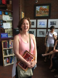 Photo of Stefani Novik standing in line at Pancake Pantry, holding a copy of the piano/vocal score for A Roadkill Opera