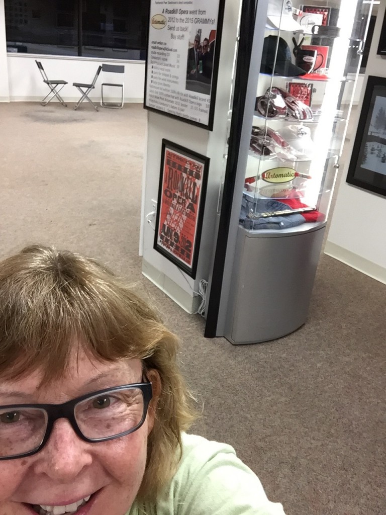 Photo of DJ Choupin with display case in background 