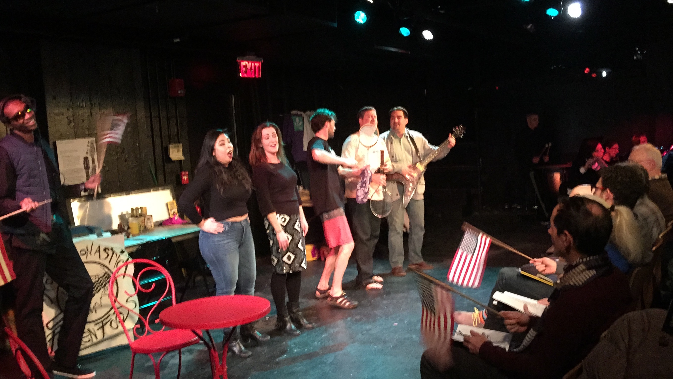 Photo of the cast and audience with flags