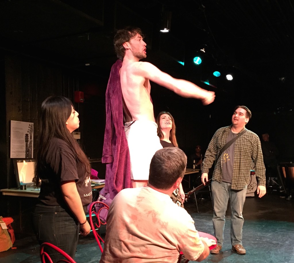 Photo of Eddie standing on a chair gesturing as Debby, Holly, Stephan, and Dave look on