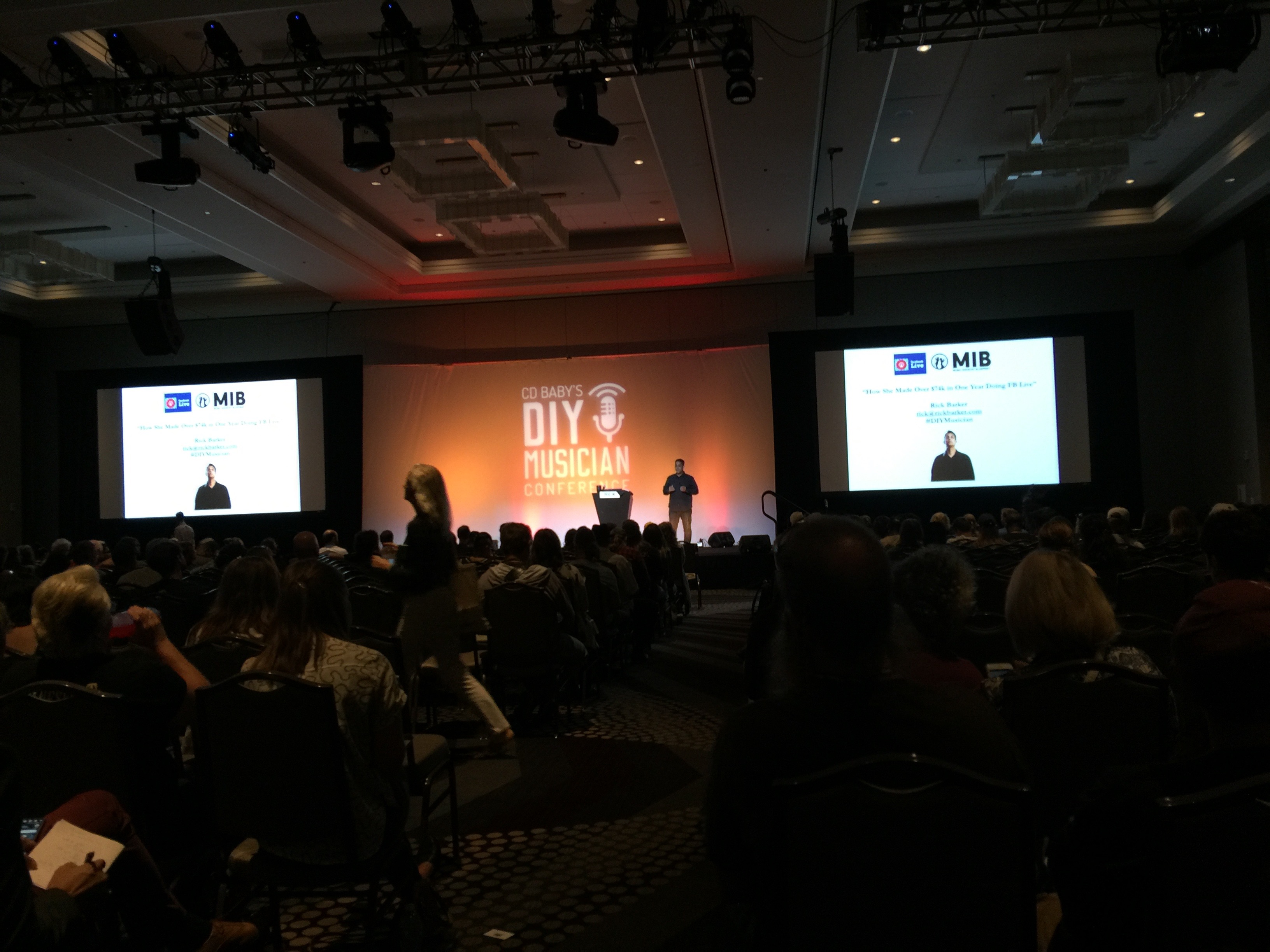 Photo of Rick Barker keynote on huge stage with la crowd of 1,000 to 1,500 people at CD Baby's DIY Musicians Conference 2017 in Nashville, Tennessee