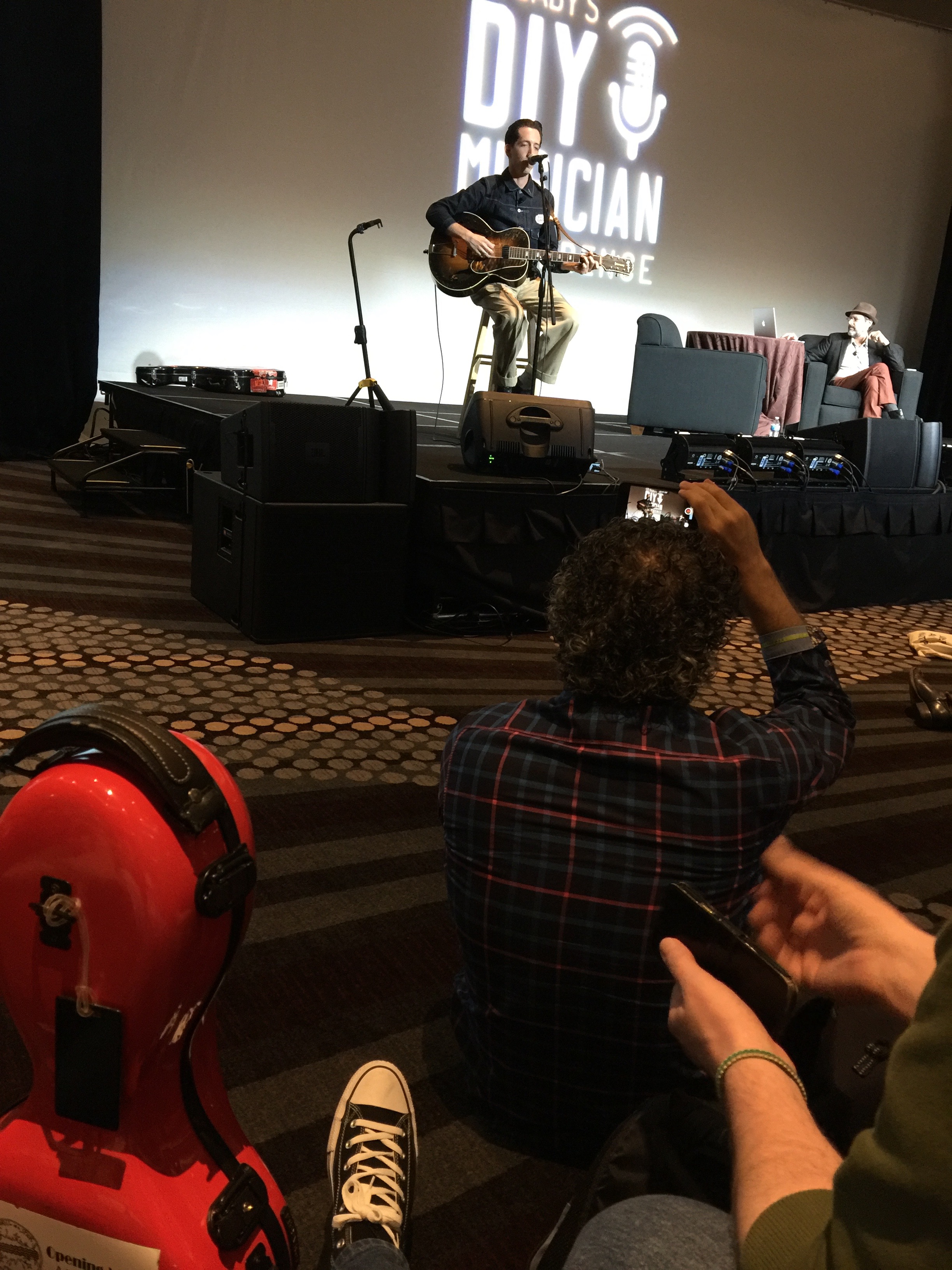 Photo of Pokey LaFarge and Bob Boilen with Dmitri Vietze watching at CD Baby's DIY Musicians Conference 2017 in Nashville, Tennessee