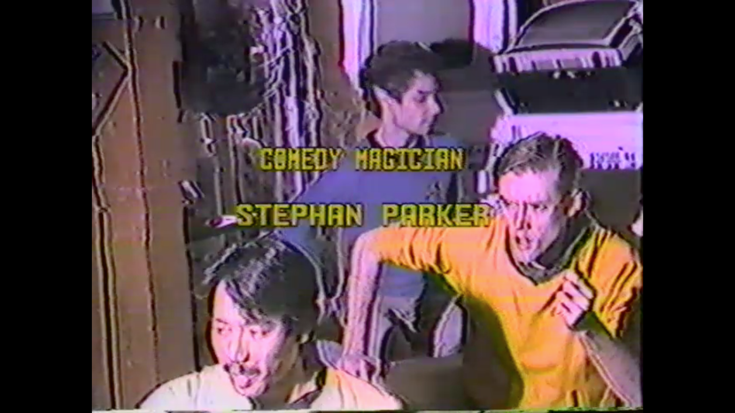 Screen shot of credits showing text "Comedy Magician Stephan Parker" over a photo of The Very Famous Friday Club Players in character and costumed as Star Trek's Sulu, Spock, and Captain Kirk
