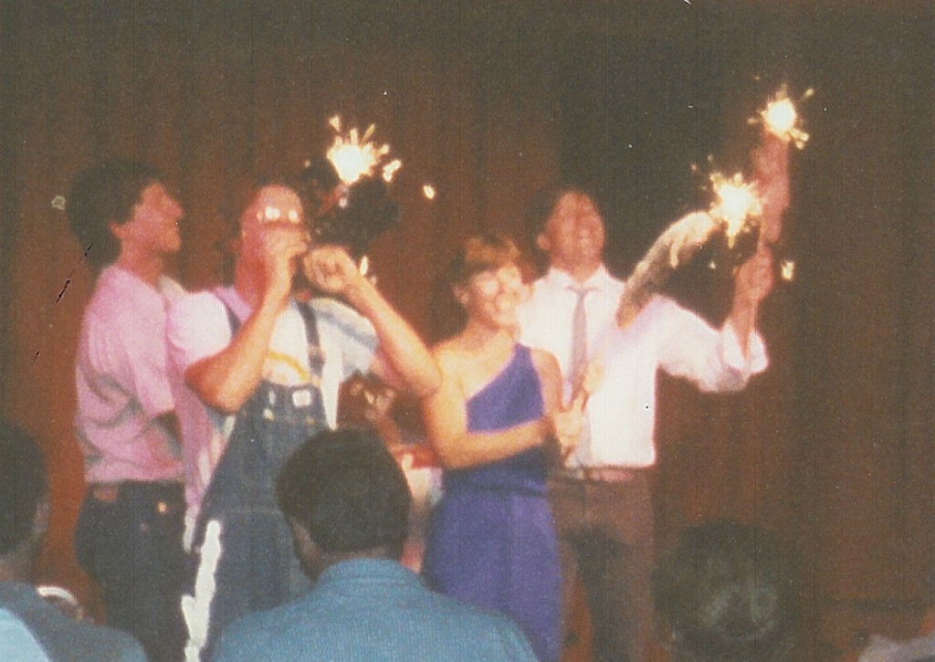 Photo: Ed Bachtel performs the national anthem as Stephan Alexander Parker, Holly Danner, and Dave Rohrer hold roadkills on a stick with sparklers to a standing ovation at the sold-out final 1988 performance of Roadkill Live!!!